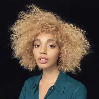 Woman with blonde voluminous curly bob hairstyle