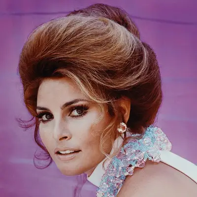 Raquel Welch wears a loose brunette beehive hairstyle in the 1960s