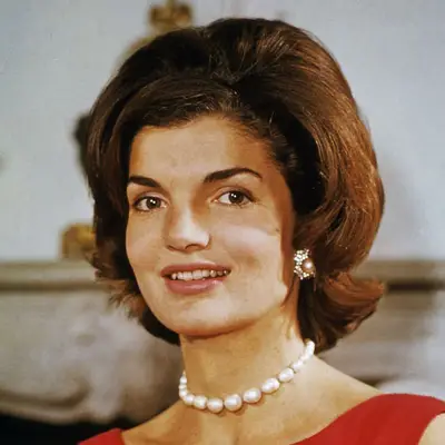 Jackie Kennedy wears a flipped bob hairstyle with teased roots in 1960