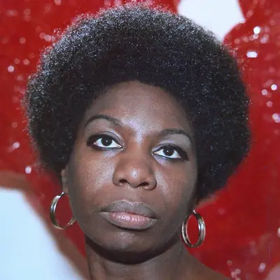 Nina Simone wears an Afro hairstyle and hoop earrings in 1968
