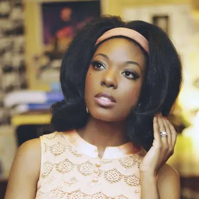 Vintage singer Tammi Savoy wears an Aretha Franklin-inspired long bob with headband