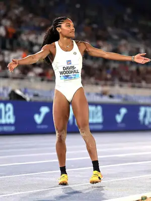 Tara Davis-Woodhall at the olympics wearing white leotard on track field