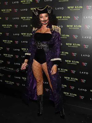 Saffi Karina dressed up as a pirate with curly hair wearing black, purple, and gold colors