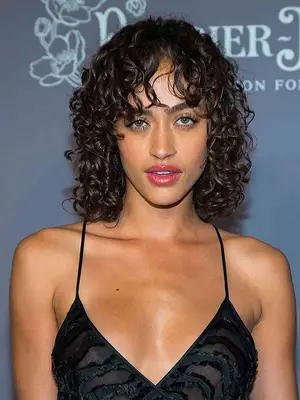 model with Curly-to-Straight Curtain Bangs