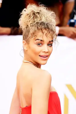 Jasmine Sanders with curly bun and fringe 