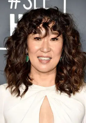 Sandra Oh curly bangs and shoulder-length hair