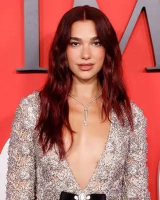 Dua Lipa with middle part and loose waves 