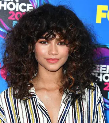 Zendaya curly mid-length hair with fringe