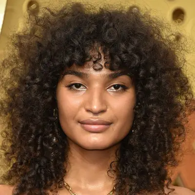 Indya Moore wears a curly wolf cut with lightweight volume