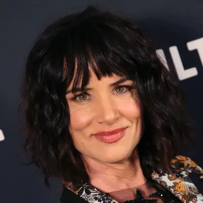 Juliette Lewis wears a wavy bob-length wolf cut hairstyle