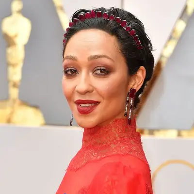 Ruth Negga with short curly hair and a red headband at the 2017 Academy Awards in Hollywood, California