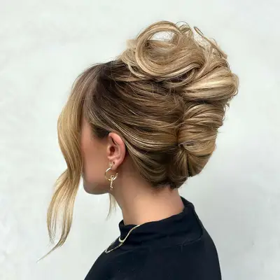 Rear view of a woman with blonde hair in a French twist style