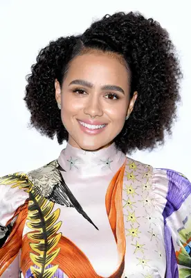 Nathalie Emmanuel with side-parted curly hair at the 2019 BAFTA Los Angeles + BBC America TV Tea Party in Beverly Hills, California