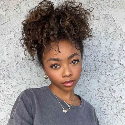 Actor Skai Jackson with a curly high ponytail