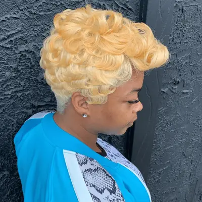 Curled pixie with platinum and strawberry blonde highlights