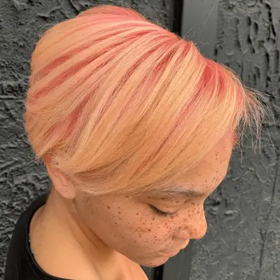 Pink-toned strawberry blonde hair with snakeskin bow