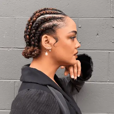 Tessa Thompson with strawberry blonde highlighted goddess braids in low bun