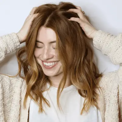 Tousled shoulder length hair with strawberry blonde ends