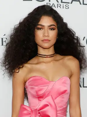 Zendaya long, curly, voluminous all-over dark brown hair