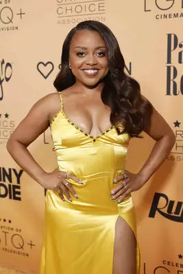 Quinta Brunson wearing long brown wavy hair