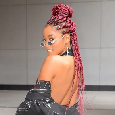 Keke Palmer wearing red, jumbo-sized braids