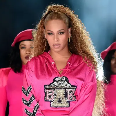 Beyonce wearing a curly, half up, half down hairstyle at Coachella