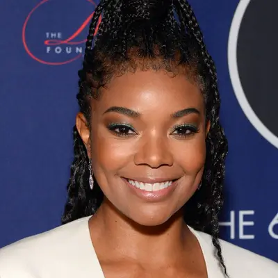 Gabrielle Union wearing braids in a half up, half down style with baby hairs