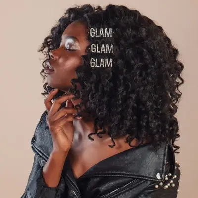 A Black woman wearing statement clips on top of her curls