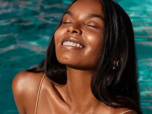 woman with long black hair in swimming pool
