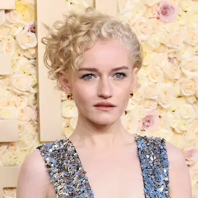 Julia Garner wears tight natural tendrils in her cropped haircut to the Golden Globes