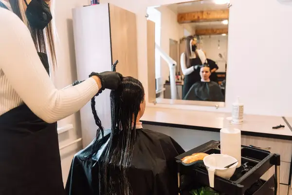 Woman laughing with long shiny black hair