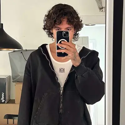 Dominic Fike with curly bowl cut 