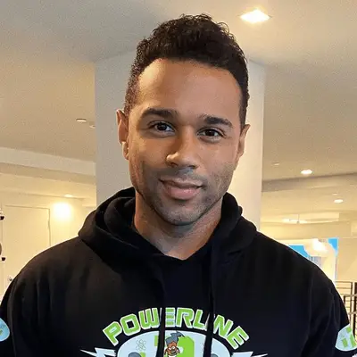 Dev Patel wears a grown-out wavy hairstyle with facial hair