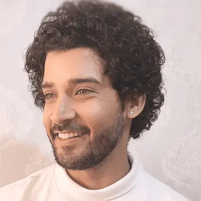 Timothee Chalamet wears a wavy shag hairstyle