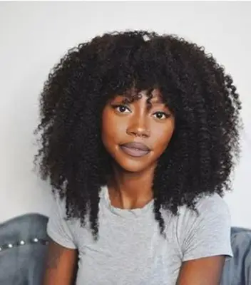 Woman with natural, layered lob and bangs