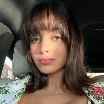 Melissa Barreram with shoulder length flipped out hair with bangs