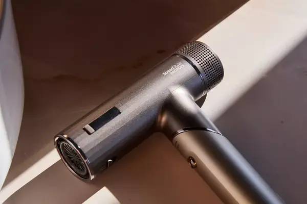 Blue and gold Dyson Supersonic Hair Dryer with attachments shown