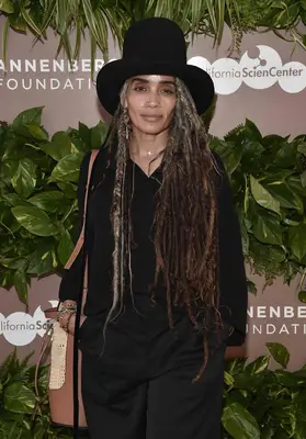 Lisa Boney wearing braided locs with a hat
