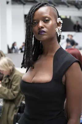 Kelala wearing locs and a shaved head