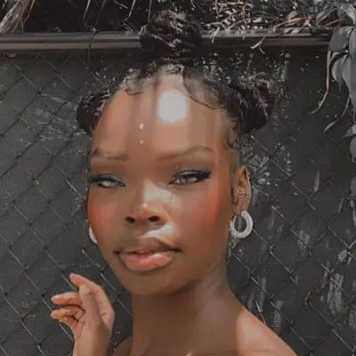 Woman with locs in bantu knots hairstyle
