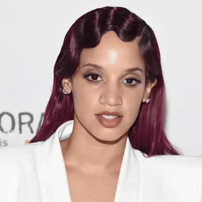 Dascha Polanco wears long burgundy finger waves to Orangecon