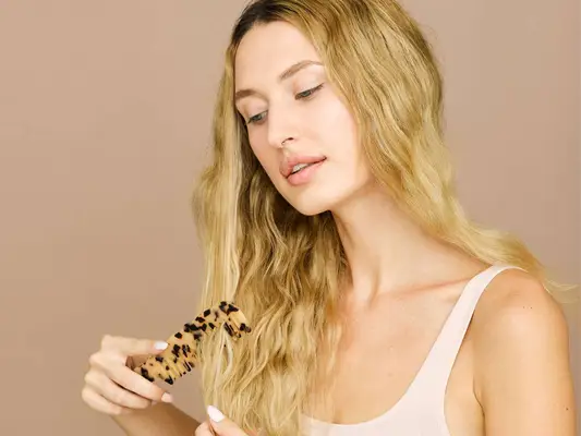 woman combing her blonde hair