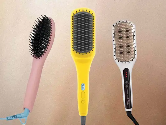 Three hair straightening brushes on a tan background