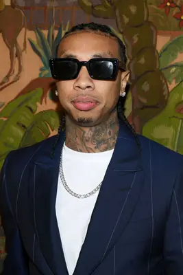 Tyga wearing sunglasses and shoulder-length braids