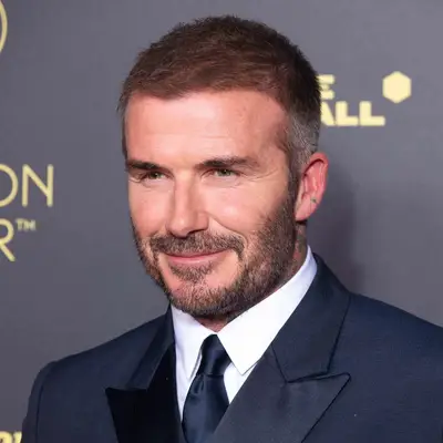 David Beckham with tight fade and navy suit at the 67th Ballon D