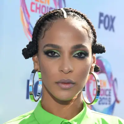 Megalyn Echikunwoke wears a twisted bantu knot hairstyle with flat top and center part