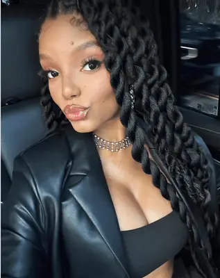 Woman with shoulder length loosely twisted hairstyle with gold beads