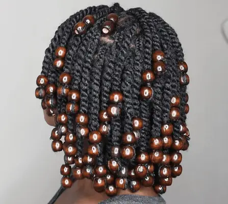 woman wearing short twist hairstyle with brown beads