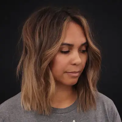 Woman with bronze face-framing highlights