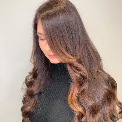 Woman with long hair and sun-kissed bronze highlights